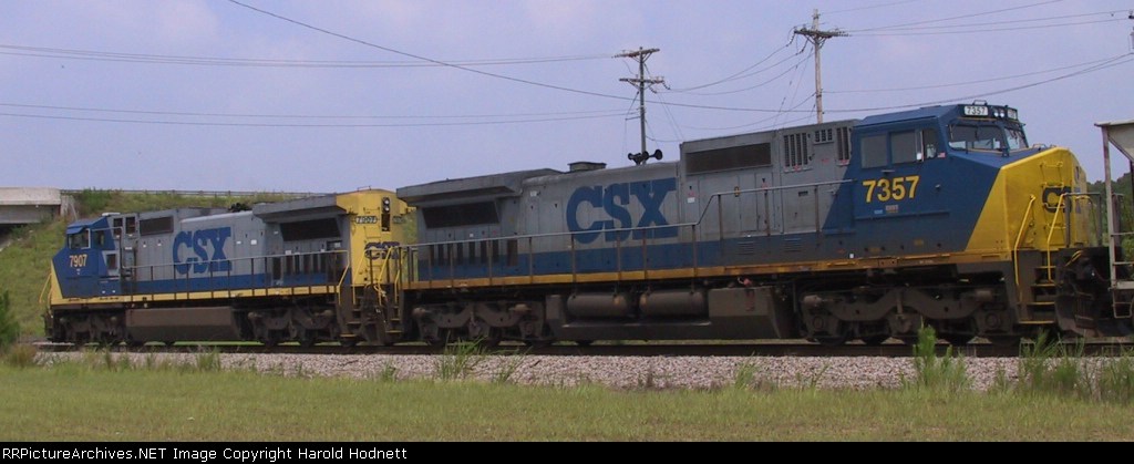 CSX 7907 & 7357 bring a train through town